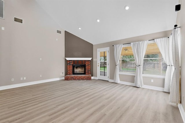 5008 Barlow Dr, Round Rock, TX 78681 - unfurnished living room with high vaulted ceiling, light wood finished floors, recessed lighting, and a brick fireplace