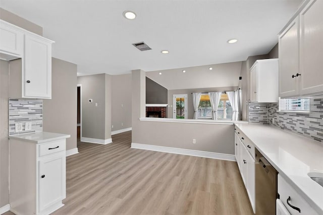 5008 Barlow Dr, Round Rock, TX 78681 - kitchen with dishwasher, white cabinetry, light countertops, light wood-style flooring, and recessed lighting