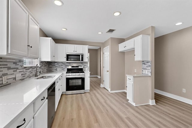5008 Barlow Dr, Round Rock, TX 78681 - kitchen with appliances with stainless steel finishes, light wood-style flooring, decorative backsplash, light countertops, and recessed lighting