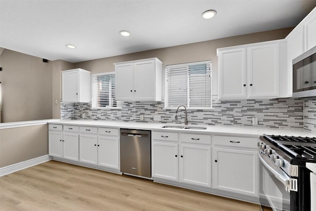 5008 Barlow Dr, Round Rock, TX 78681 - kitchen featuring appliances with stainless steel finishes, tasteful backsplash, white cabinets, light countertops, and light wood-style flooring