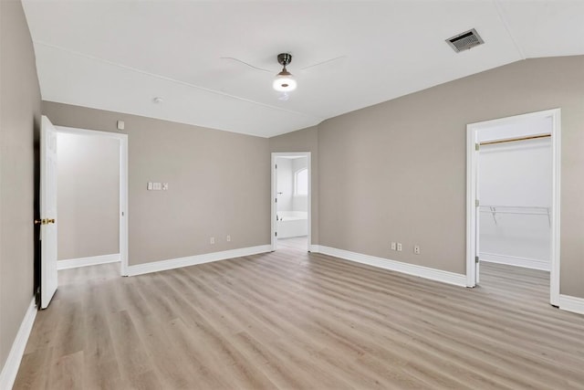 5008 Barlow Dr, Round Rock, TX 78681 - empty room featuring light wood-type flooring and vaulted ceiling