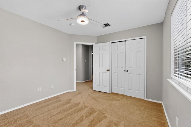 5008 Barlow Dr, Round Rock, TX 78681 - unfurnished bedroom with light colored carpet, a closet, and a ceiling fan