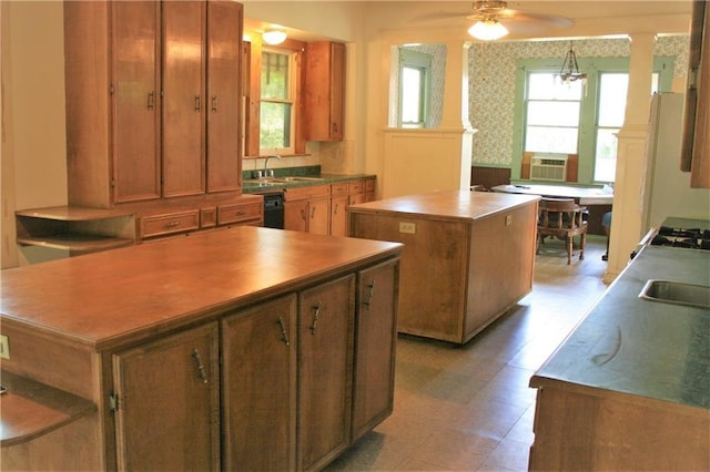 422 W N Main St, Flatonia, TX 78941 - kitchen with a center island, decorative columns, ceiling fan, and brown cabinets
