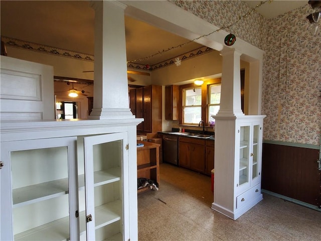 422 W N Main St, Flatonia, TX 78941 - kitchen with ornate columns, dishwasher, wallpapered walls, a wainscoted wall, and light flooring