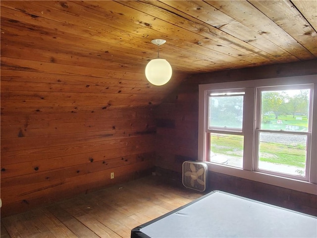 additional living space featuring lofted ceiling, wooden ceiling, hardwood / wood-style flooring, and wooden walls