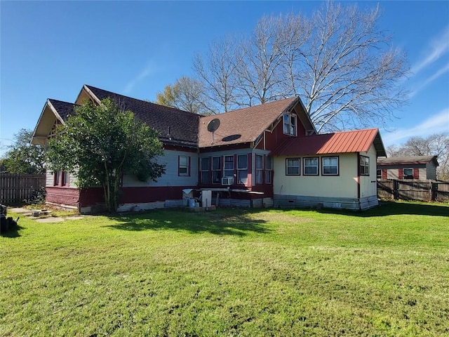 back of house featuring a yard, crawl space, and fence