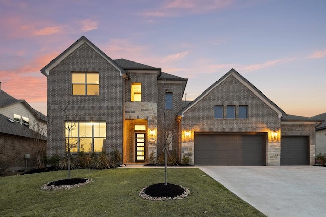 5824 Antelope Well Ln, Austin, TX 78738 - view of front of home with brick siding, concrete driveway, a front yard, and a garage