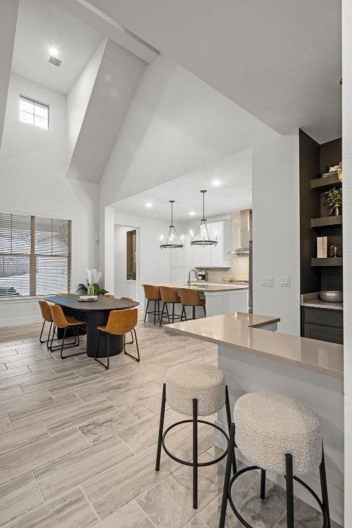 5824 Antelope Well Ln, Austin, TX 78738 - dining room featuring a high ceiling, a chandelier, and recessed lighting