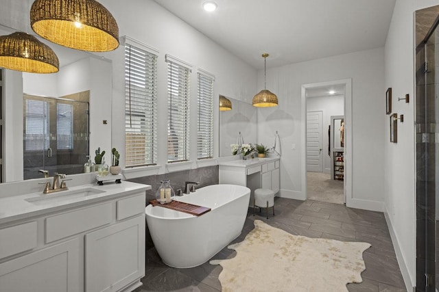 5824 Antelope Well Ln, Austin, TX 78738 - bathroom with a shower stall, vanity, a soaking tub, baseboards, and recessed lighting