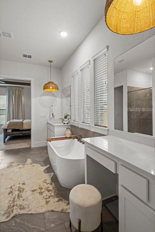 5824 Antelope Well Ln, Austin, TX 78738 - full bathroom with a soaking tub, a tile shower, vanity, recessed lighting, and baseboards