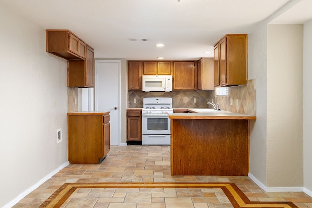 kitchen with white appliances, visible vents, brown cabinets, and decorative backsplash