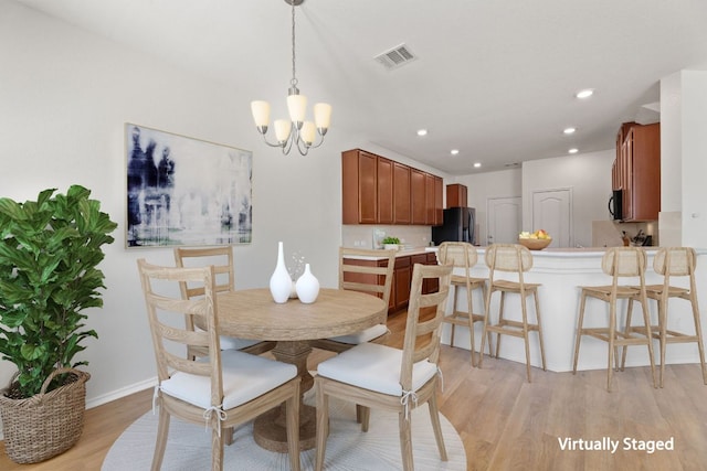 dining area with recessed lighting, a notable chandelier, visible vents, baseboards, and light wood-type flooring