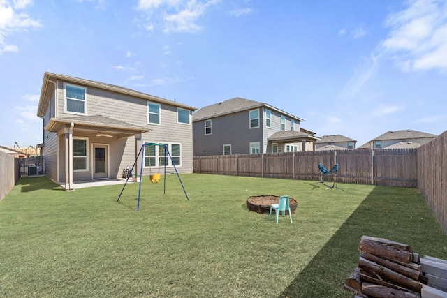 back of house featuring a fenced backyard and a lawn