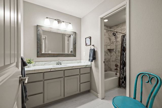 full bath featuring shower / bath combo, marble finish floor, and vanity