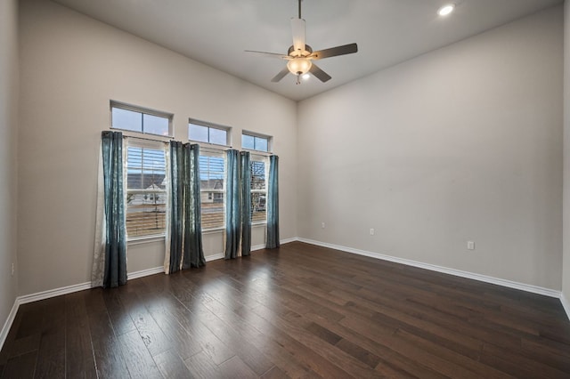 empty room with ceiling fan, recessed lighting, wood-type flooring, and baseboards