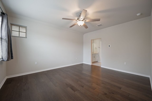 empty room featuring a ceiling fan, baseboards, visible vents, and wood finished floors