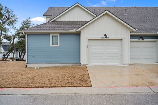 305 Bolivar Way Unit 101, San Marcos, TX 78666 - view of front facade with a garage, roof with shingles, driveway, and board and batten siding