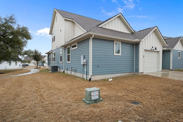 view of side of property with a garage, a shingled roof, cooling unit, and board and batten siding