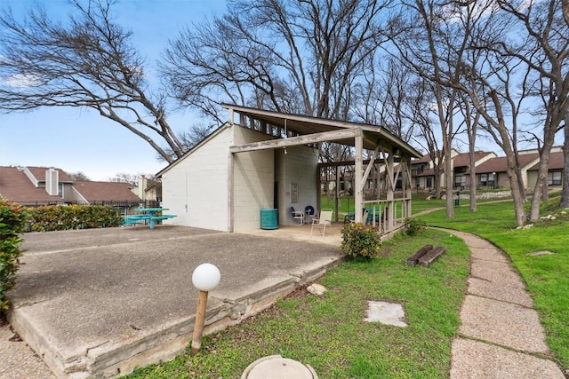 exterior space featuring concrete block siding and a yard