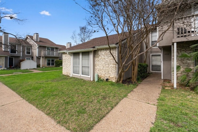 view of front of home featuring a front yard and stone siding