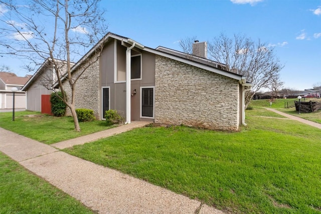 mid-century modern home featuring stone siding, a chimney, and a front lawn