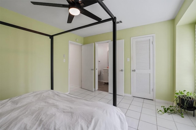 unfurnished bedroom featuring visible vents, ceiling fan, connected bathroom, baseboards, and tile patterned floors