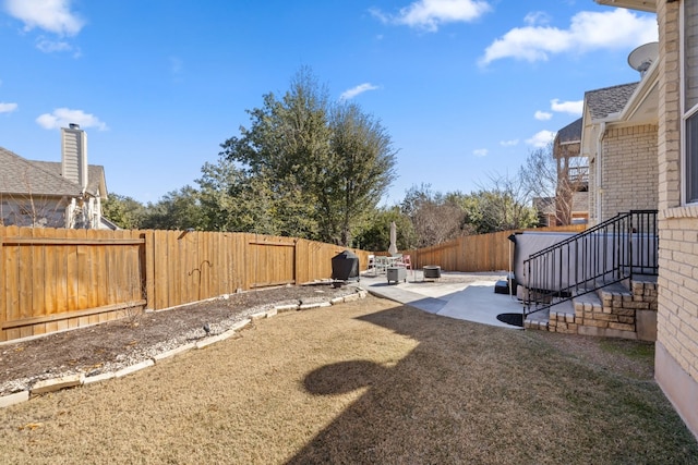 view of yard featuring a patio and a fenced backyard