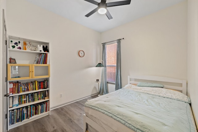 bedroom with ceiling fan and wood finished floors