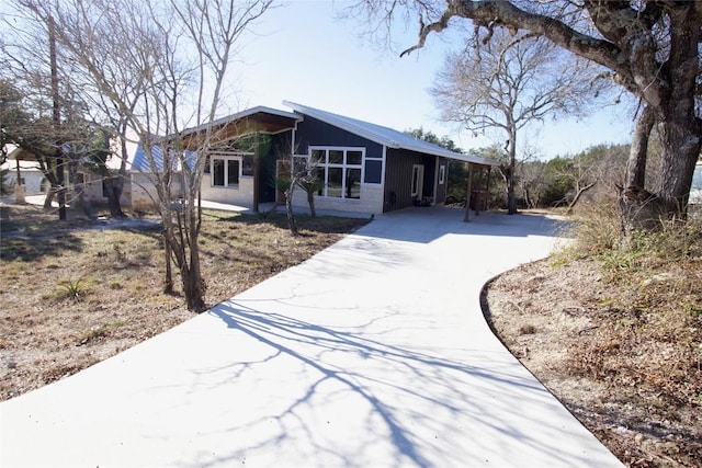 mid-century inspired home with driveway