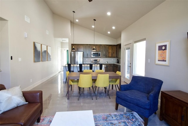 dining area featuring baseboards, high vaulted ceiling, visible vents, and recessed lighting