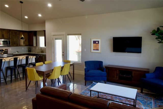 tiled living area with lofted ceiling, baseboards, a sink, and recessed lighting