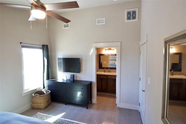 bedroom with visible vents and a high ceiling