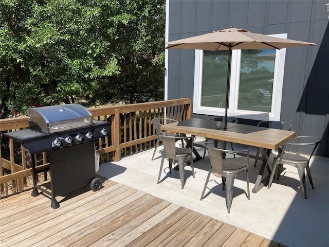 wooden terrace featuring outdoor dining area and area for grilling