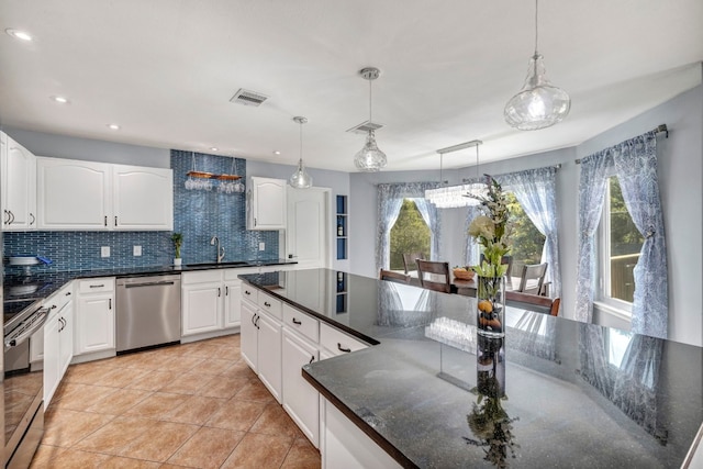 15401 Montoya Cv, Austin, TX 78717 - kitchen with appliances with stainless steel finishes, a sink, decorative backsplash, decorative light fixtures, and recessed lighting