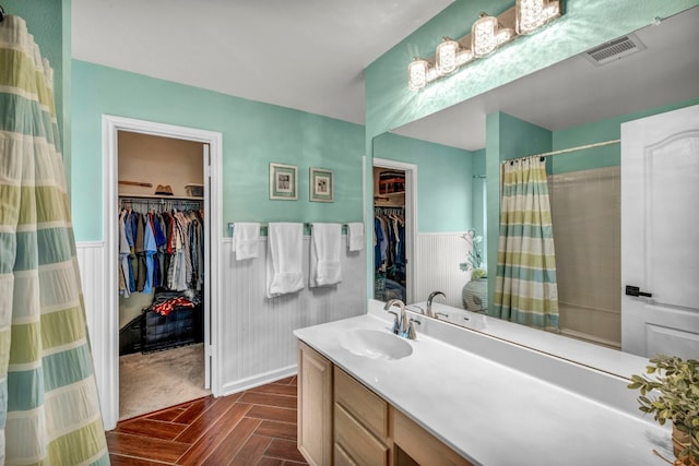 15401 Montoya Cv, Austin, TX 78717 - bathroom featuring a wainscoted wall, a shower with shower curtain, vanity, and a spacious closet