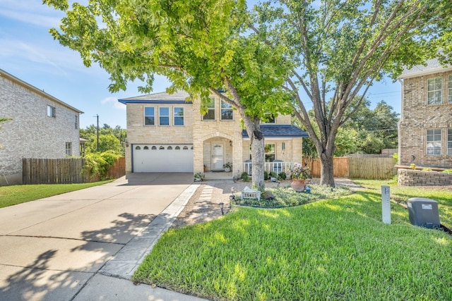 traditional-style house with an attached garage, fence, stone siding, driveway, and a front lawn