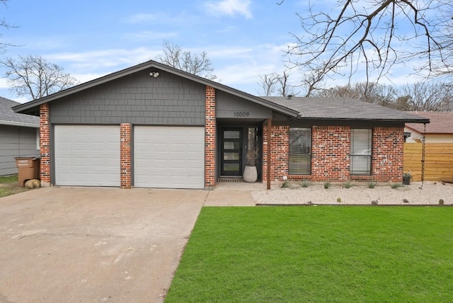 view of front facade featuring an attached garage, brick siding, concrete driveway, and a front yard