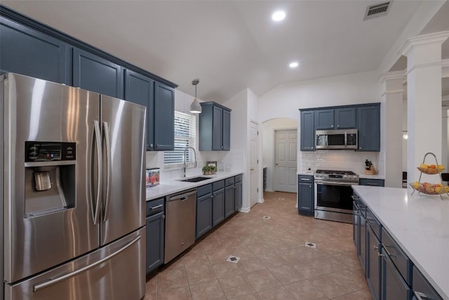 kitchen with visible vents, decorative backsplash, appliances with stainless steel finishes, vaulted ceiling, and a sink