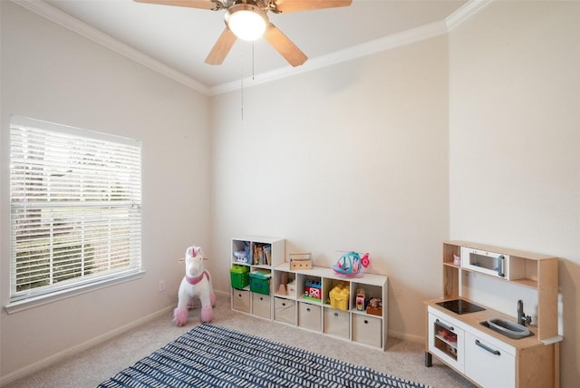 rec room with carpet floors, crown molding, and baseboards