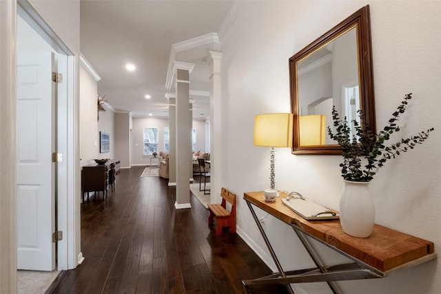 corridor featuring recessed lighting, baseboards, ornamental molding, dark wood finished floors, and ornate columns