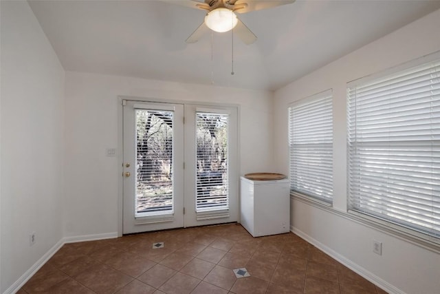 doorway with tile patterned flooring, baseboards, and a wealth of natural light