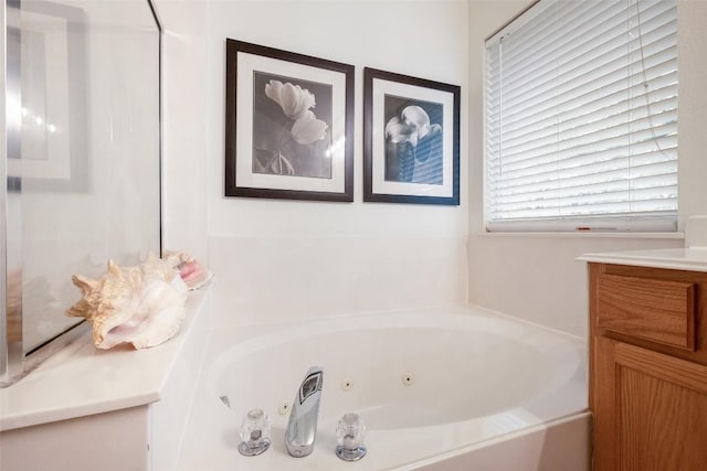 bathroom with a whirlpool tub and vanity