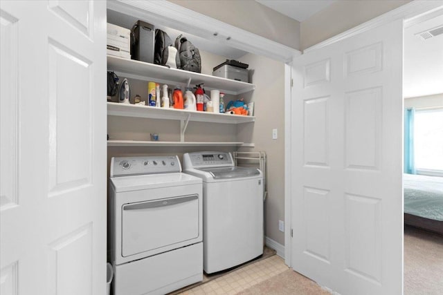 washroom featuring laundry area, baseboards, visible vents, washing machine and clothes dryer, and light floors