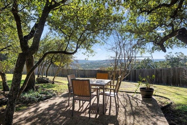 view of patio with outdoor dining area and a fenced backyard