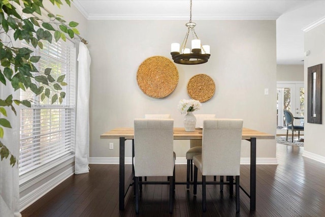 dining space with dark wood-style floors, crown molding, baseboards, and a notable chandelier