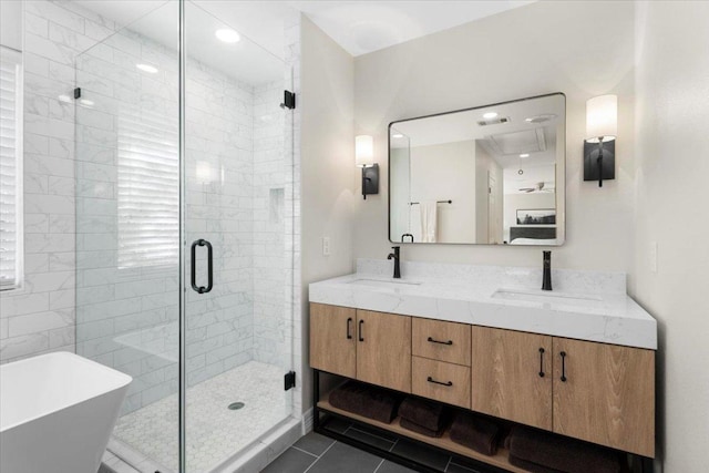 full bath featuring double vanity, tile patterned flooring, a shower stall, and a sink