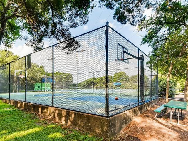 view of basketball court with community basketball court and fence