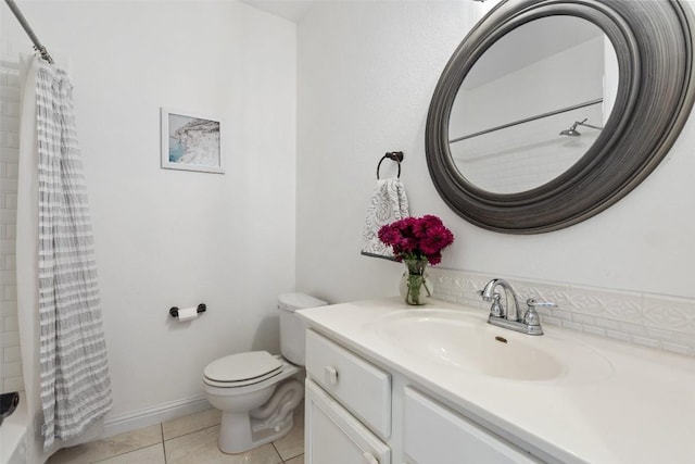 full bath featuring tile patterned flooring, baseboards, vanity, and toilet