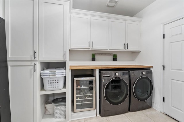 laundry area featuring cabinet space, beverage cooler, light tile patterned floors, visible vents, and washer and dryer