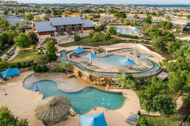 view of pool featuring a residential view, a water play area, and a patio